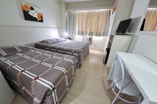 a hotel room with two beds and a television at klein Ville Esteio Br in Esteio