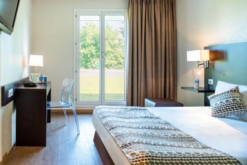Un pat sau paturi într-o cameră la Kyriad Laon