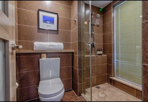 a bathroom with a toilet and a glass shower at Atour Hotel Xi'an Gaoxin Tangyan Road Branch in Xi'an