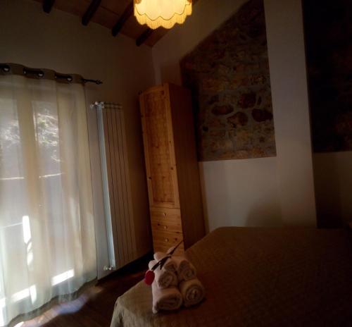 a bedroom with a bed and a window at Casetta degli Etruschi ALLOGGIO TURISTICO in Allumiere
