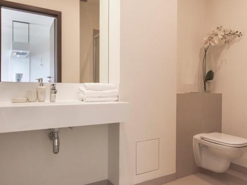 een badkamer met een wastafel en een toilet bij VacationClub – Baltic Park Molo Apartament C104 in Świnoujście