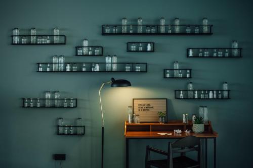 a room with a desk with a lamp and glasses on the wall at Vienna House by Wyndham Amber Baltic Miedzyzdroje in Międzyzdroje