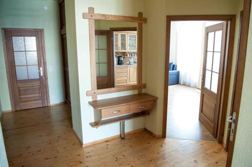 a room with a mirror and a dresser in a room at Center Orange house in Cēsis