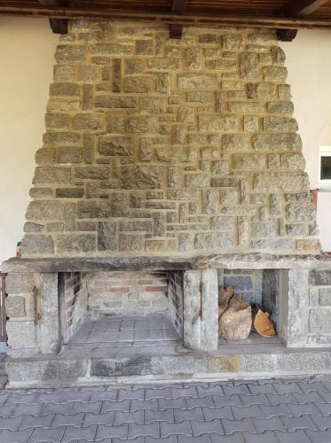 a stone fireplace in front of a brick wall at Penzion Cerhenice in Cerhenice