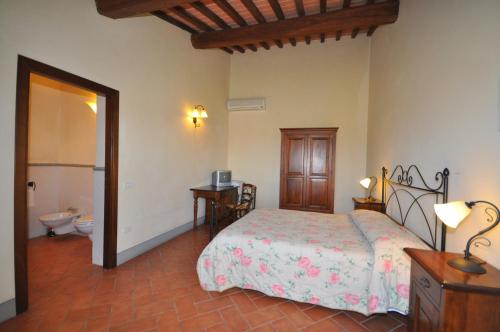 a bedroom with a bed and a toilet at Agriturismo Musignano in Cerreto Guidi