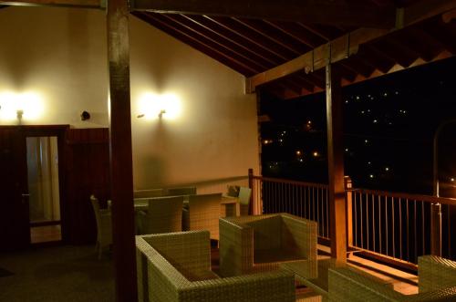 a patio with chairs and a table on a balcony at To Kastri in Kalopanayiotis