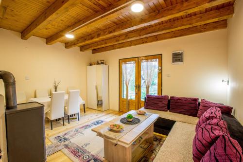 a living room with a couch and a table at Guest house Sky Blue in Žabljak