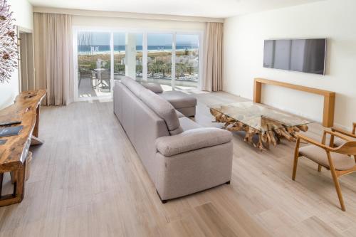 a living room with a couch and a table at Zahara Beach & Spa by QHotels - Adults Recommended in Zahara de los Atunes