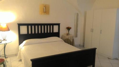 a bedroom with a bed and a table with a lamp at Casa Vacanze Gaia in Biancavilla