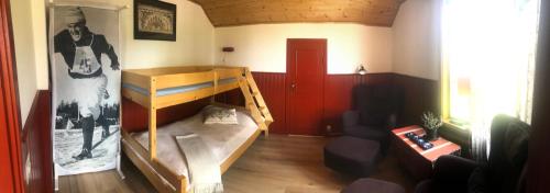 a room with a bunk bed and a couch at Prinsgården B&B rum stugor in Mora