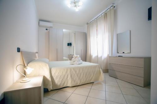 a bedroom with a bed and a dresser and a television at B&B NONNO MICHELE in Fisciano