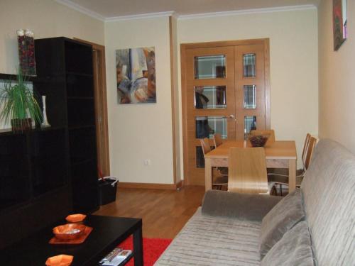 a living room with a couch and a table at Apartamento en 1ª línea de la Playa de Covas - Viveiro (Lugo) in Viveiro
