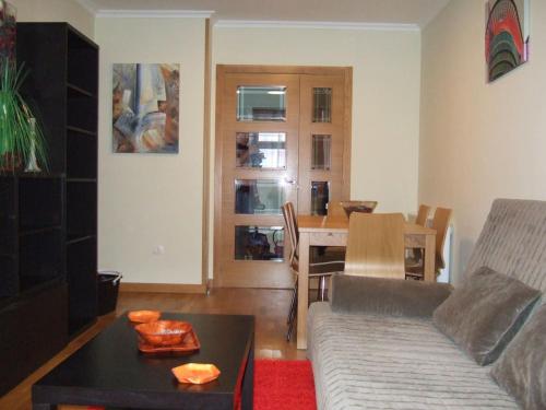 a living room with a couch and a table at Apartamento en 1ª línea de la Playa de Covas - Viveiro (Lugo) in Viveiro