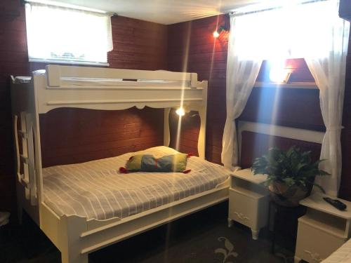 a white bunk bed in a room with a window at Prinsgården B&B rum stugor in Mora
