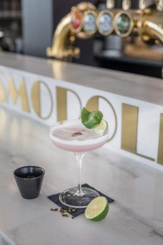 a martini glass with a lime on a counter at Hôtel Cosmopolitain in Biarritz