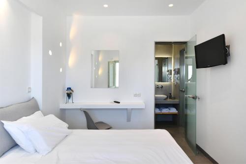A bed or beds in a room at Lorenzo Studios and Suites Paros