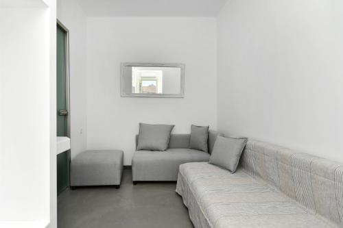 a living room with a couch and a chair at Lorenzo Studios and Suites Paros in Naousa