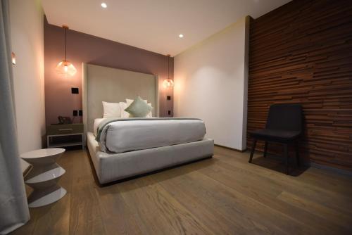 a bedroom with a bed and a desk and a chair at Casa Prim Hotel Boutique in Mexico City