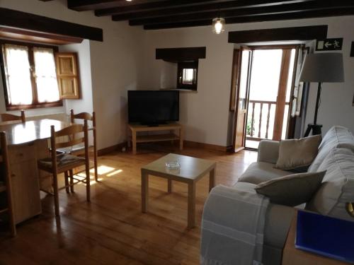 a living room with a couch and a table at La Carriella in Colombres