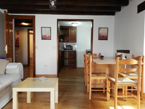 a living room with a couch and a table at La Carriella in Colombres