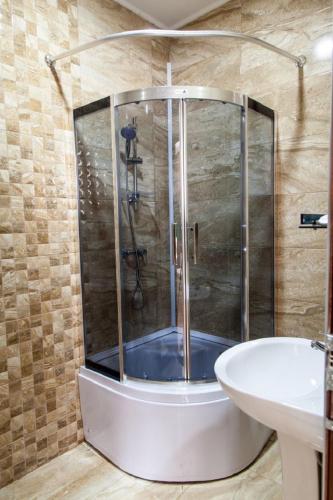 a bathroom with a shower and a sink at Hotel Old Borjomi in Borjomi