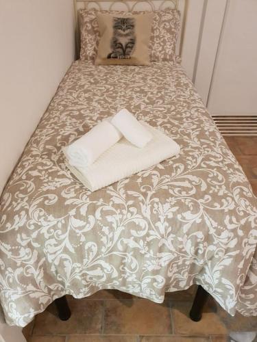 a bed with two pillows on top of it at Suite le Scuderie a "le Moline" vita in fattoria in Vetralla