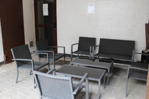 a group of chairs and tables in a room at Hotel Alsterquelle in Henstedt-Ulzburg
