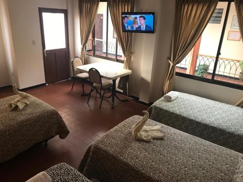 Una cama o camas en una habitación de Cittadella Hostal