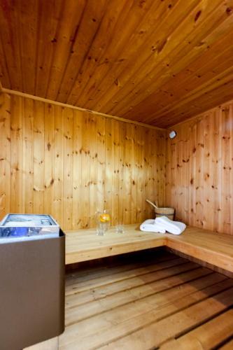 a wooden room with a bench in a sauna at Vila Nikopolis in Preveza