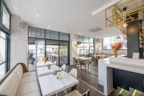 a restaurant with tables and chairs and a fireplace at Hôtel Cosmopolitain in Biarritz