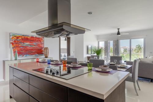 a kitchen with a large island in a living room at Mareazul Beach Front Condos At playa del Carmen in Playa del Carmen
