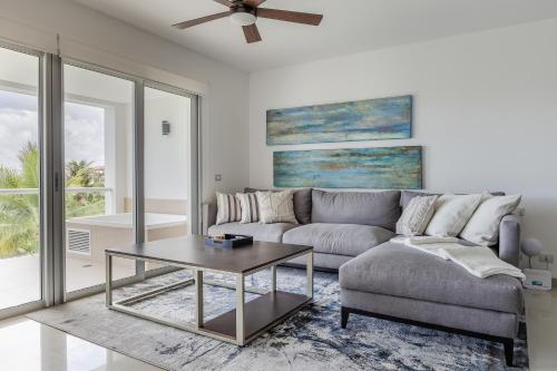 a living room with a couch and a table at Mareazul Beach Front Condos At playa del Carmen in Playa del Carmen