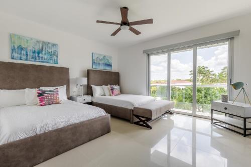 a bedroom with two beds and a ceiling fan at Mareazul Beach Front Condos At playa del Carmen in Playa del Carmen