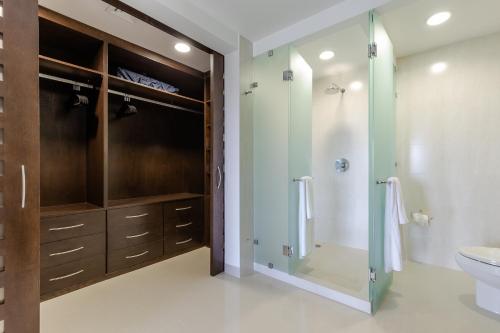 a bathroom with a glass shower and a toilet at Mareazul Beach Front Condos At playa del Carmen in Playa del Carmen