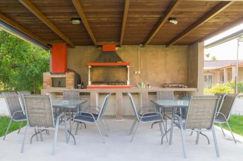 an outdoor kitchen with tables and chairs and a stove at Kremasti Rooms in Kremastí
