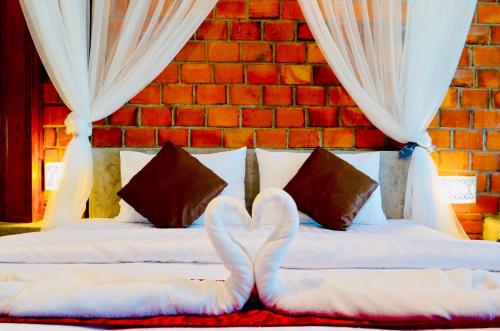 Postel nebo postele na pokoji v ubytování Khum Lanna Boutique Hotel