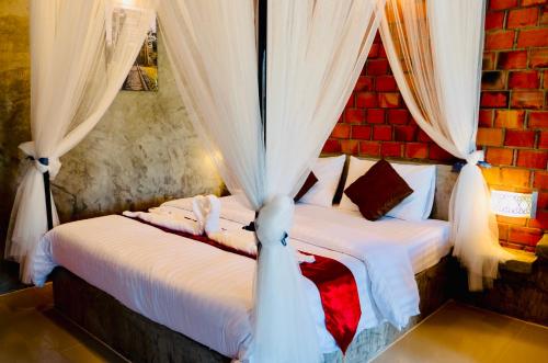 Postel nebo postele na pokoji v ubytování Khum Lanna Boutique Hotel
