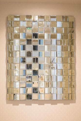 a wall of glass tiles on a wall at Hôtel Cosmopolitain in Biarritz