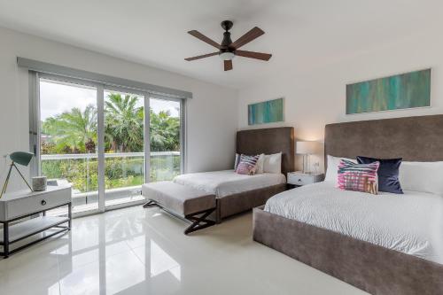 a bedroom with two beds and a window at Mareazul Beach Front Condos At playa del Carmen in Playa del Carmen