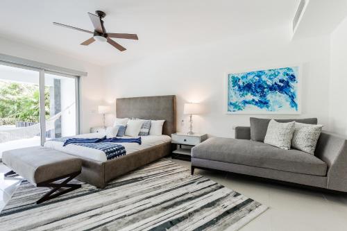 a bedroom with a bed and a couch at Mareazul Beach Front Condos At playa del Carmen in Playa del Carmen