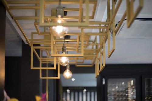 a chandelier with lights hanging from a ceiling at Hôtel Cosmopolitain in Biarritz