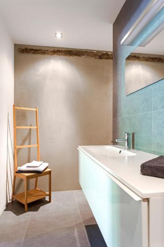 a bathroom with a sink and a wooden chair at Agriturismo Unico Senso in Montottone