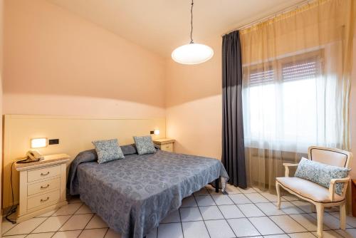 Hotel Ristorante Vecchia Maremma tesisinde bir odada yatak veya yataklar