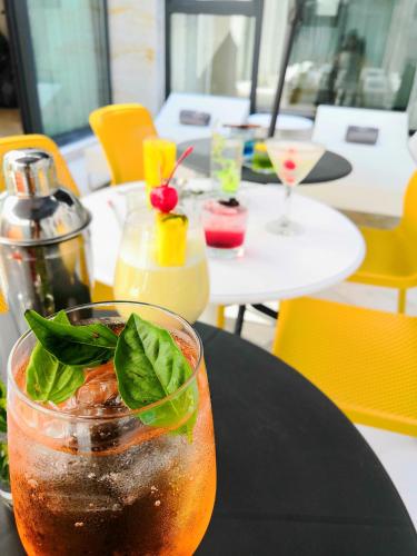 a drink sitting on a black table in a restaurant at FCH Hotel Expo Adults only in Guadalajara