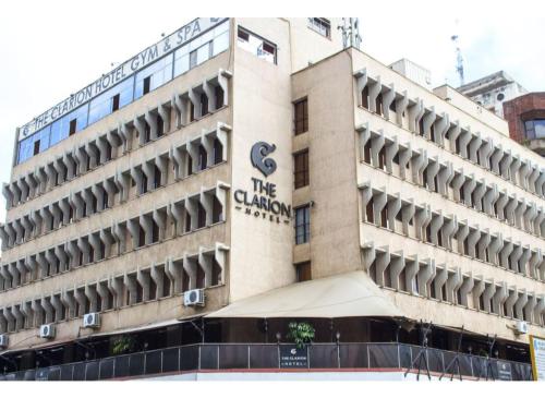 a large building with a large clock on the side of it at The Clarion Hotel in Nairobi
