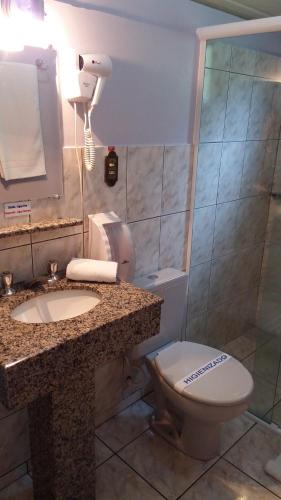y baño con aseo, lavabo y espejo. en Pousada Camponesa en Picada Cafe