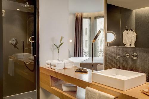 a bathroom with a sink and a mirror at Ohla Barcelona in Barcelona