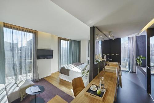 a hotel room with a bed and a dining table at Ohla Barcelona in Barcelona