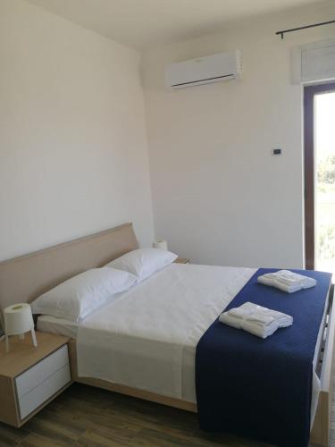 a bedroom with a bed with two towels on it at B&B Crispino in Belvedere Marittimo