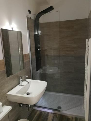 a bathroom with a sink and a glass shower at B&B Crispino in Belvedere Marittimo